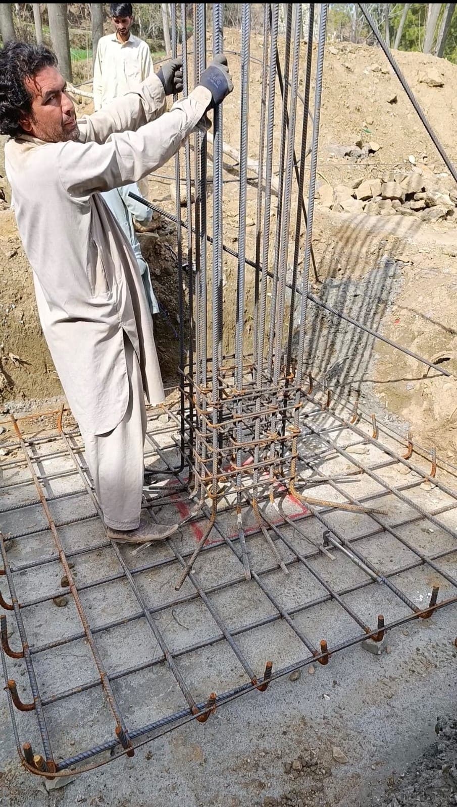 A column reinforcement cage being tied over a pad foundation