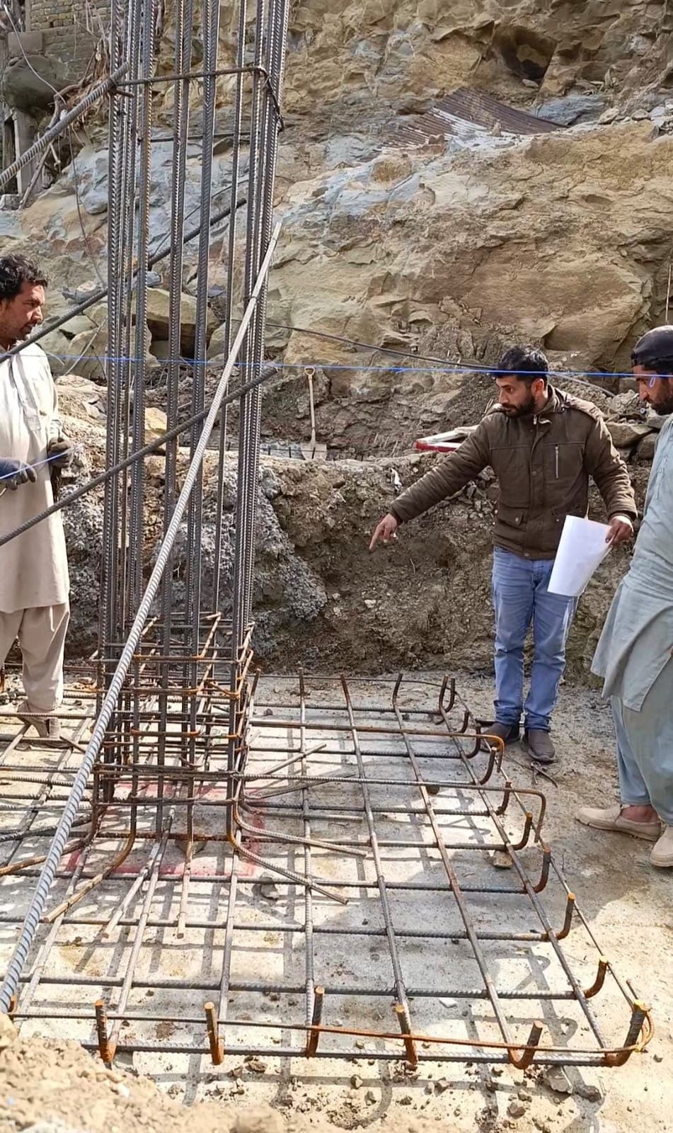 Reinforcement being set out against the drawings at a hillside footing